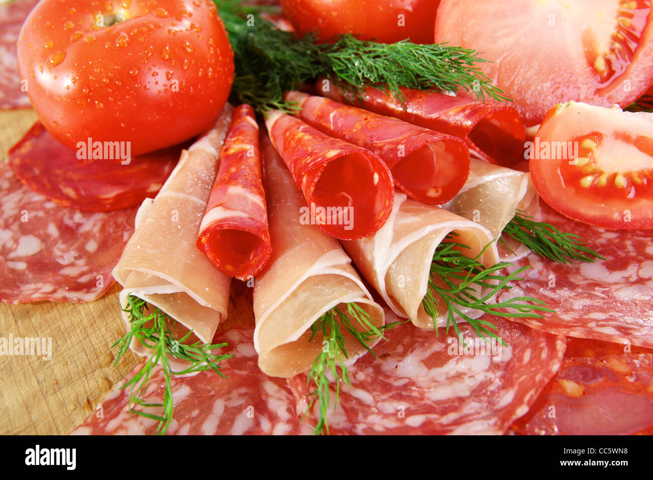 Smoked meat and salami on a wooden board Stock Photo