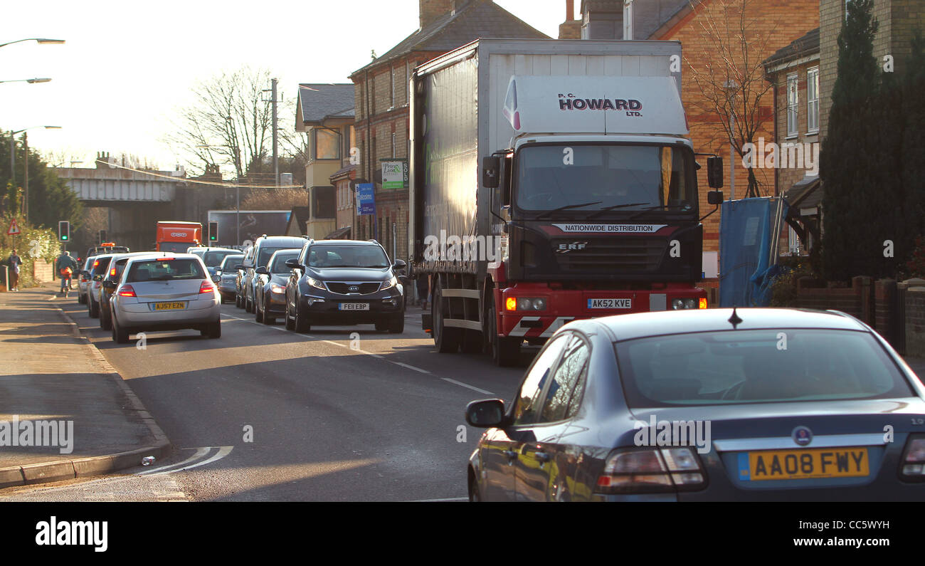A delivery lorry parked awkwardly on a busy narrow road causes traffic congestion in Huntingdon, Cambridgeshire. Stock Photo