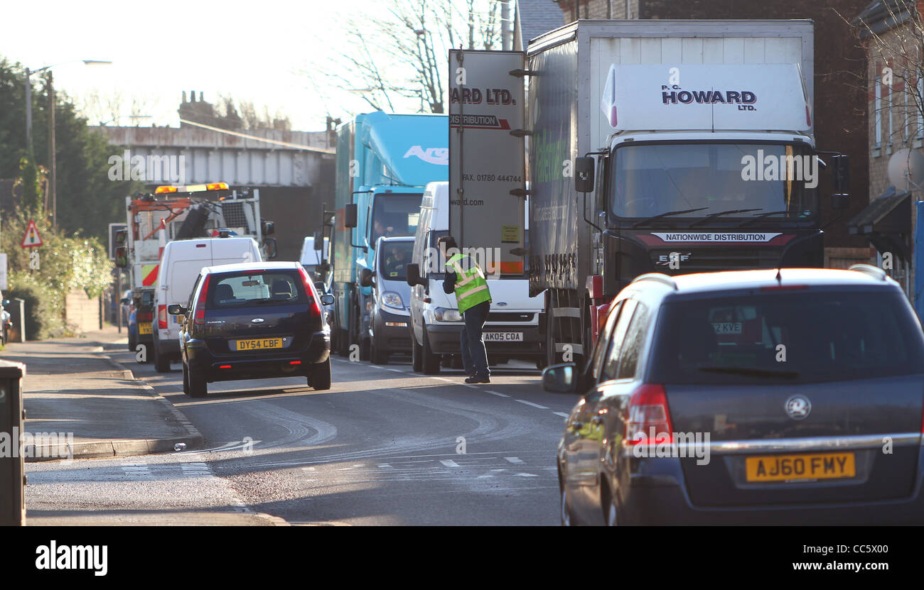 A delivery lorry parked awkwardly on a busy narrow road causes traffic congestion in Huntingdon, Cambridgeshire. Stock Photo