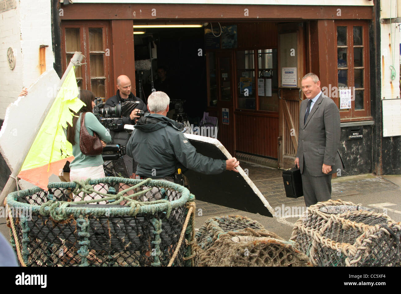 Actor Martin Clunes on the set of Doc Martin outside the lifeboat station in Port Isaac on the North Cornwall Coast. Stock Photo