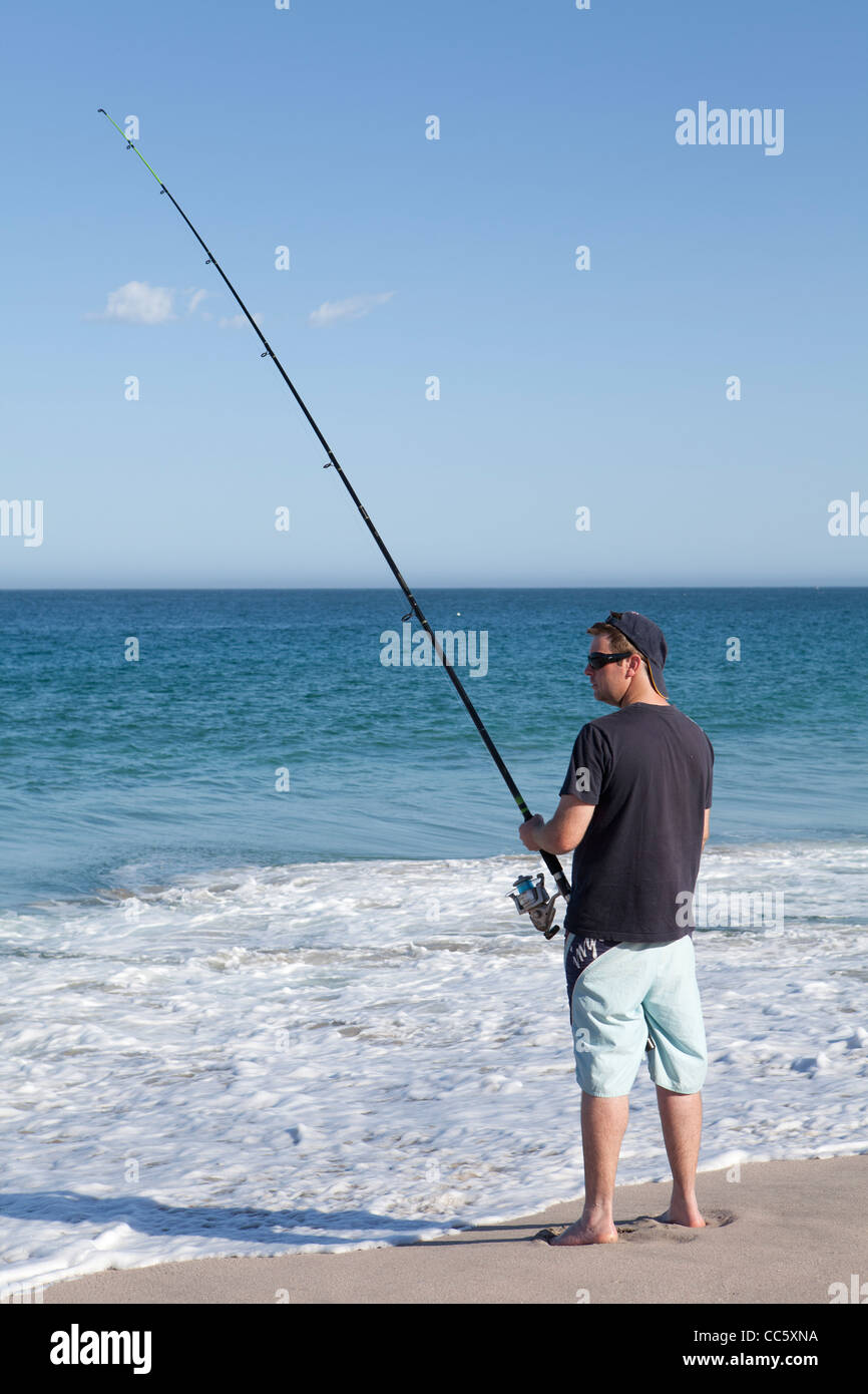 A man beach casting, fishing on the beach at Red Bluff, Kalbarri