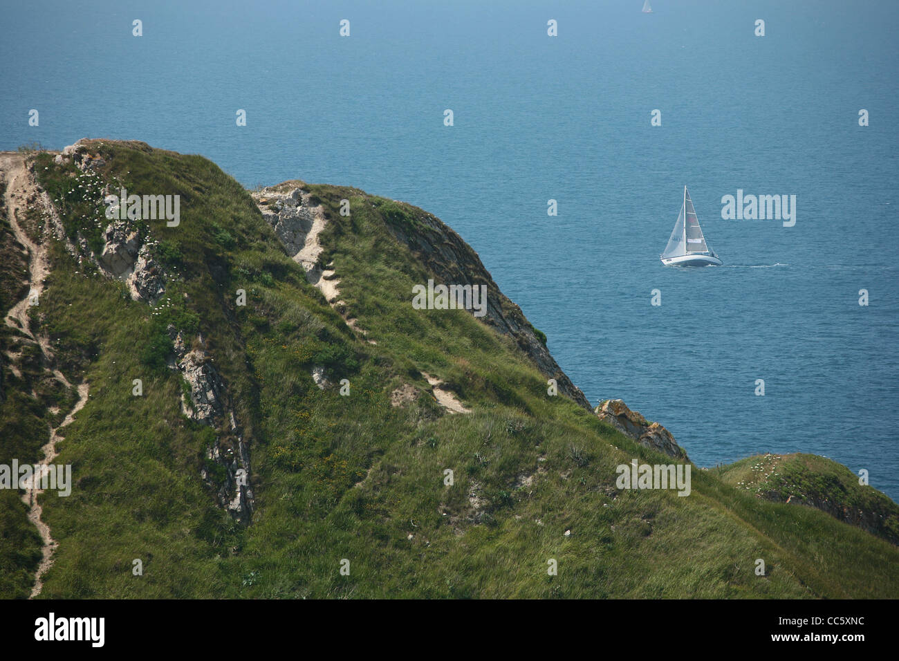 A yacht sails along the English Channel off the Dorset Coast near Durdle Door Stock Photo