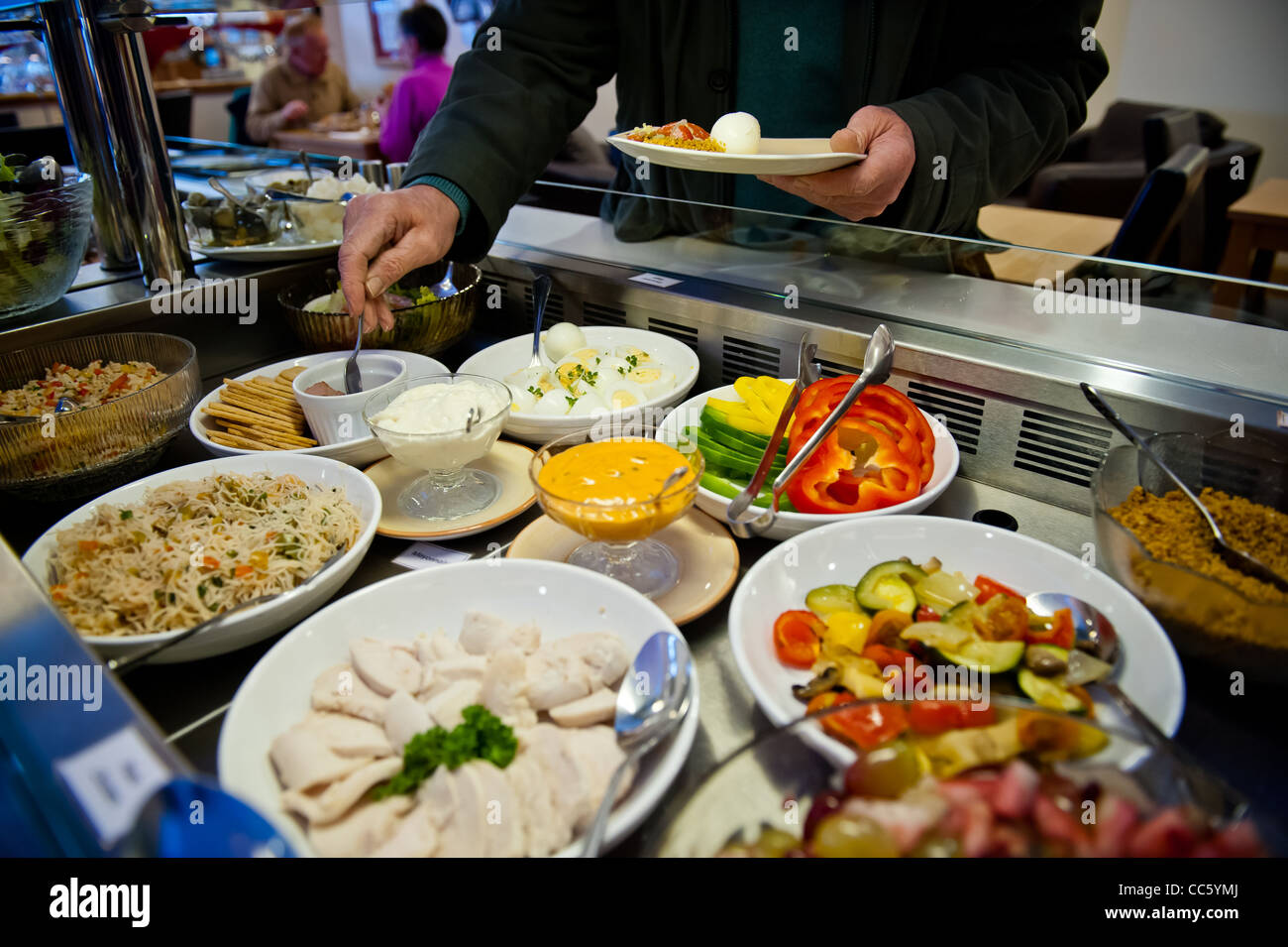 Buffet counter of salad cold meats fruits rice and pasta Stock Photo
