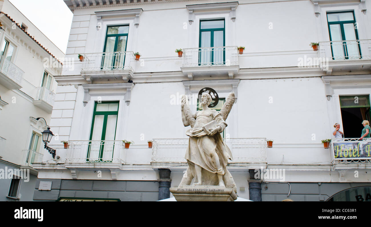 A street scene in Amalfi town by the Doumo with St Andrews statue Stock Photo