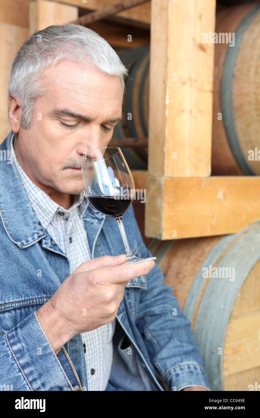 Man smelling red wine Stock Photo - Alamy