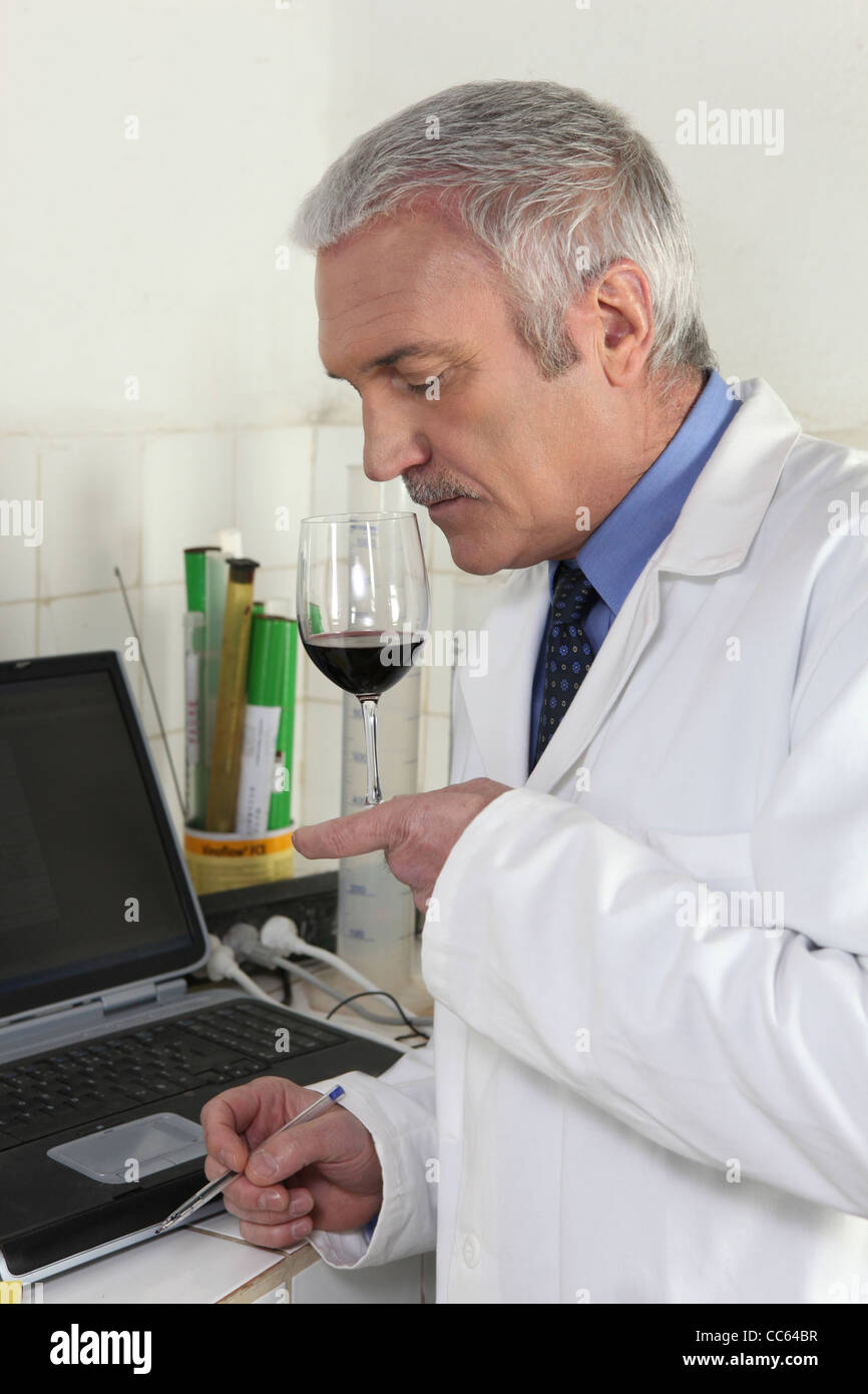 Man smelling red wine Stock Photo - Alamy