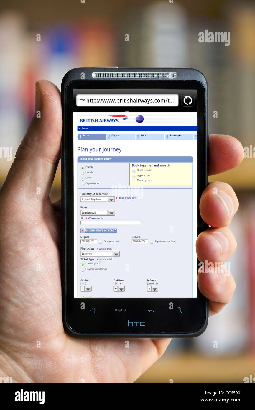 Making a booking on the British Airways website on an HTC smartphone Stock Photo