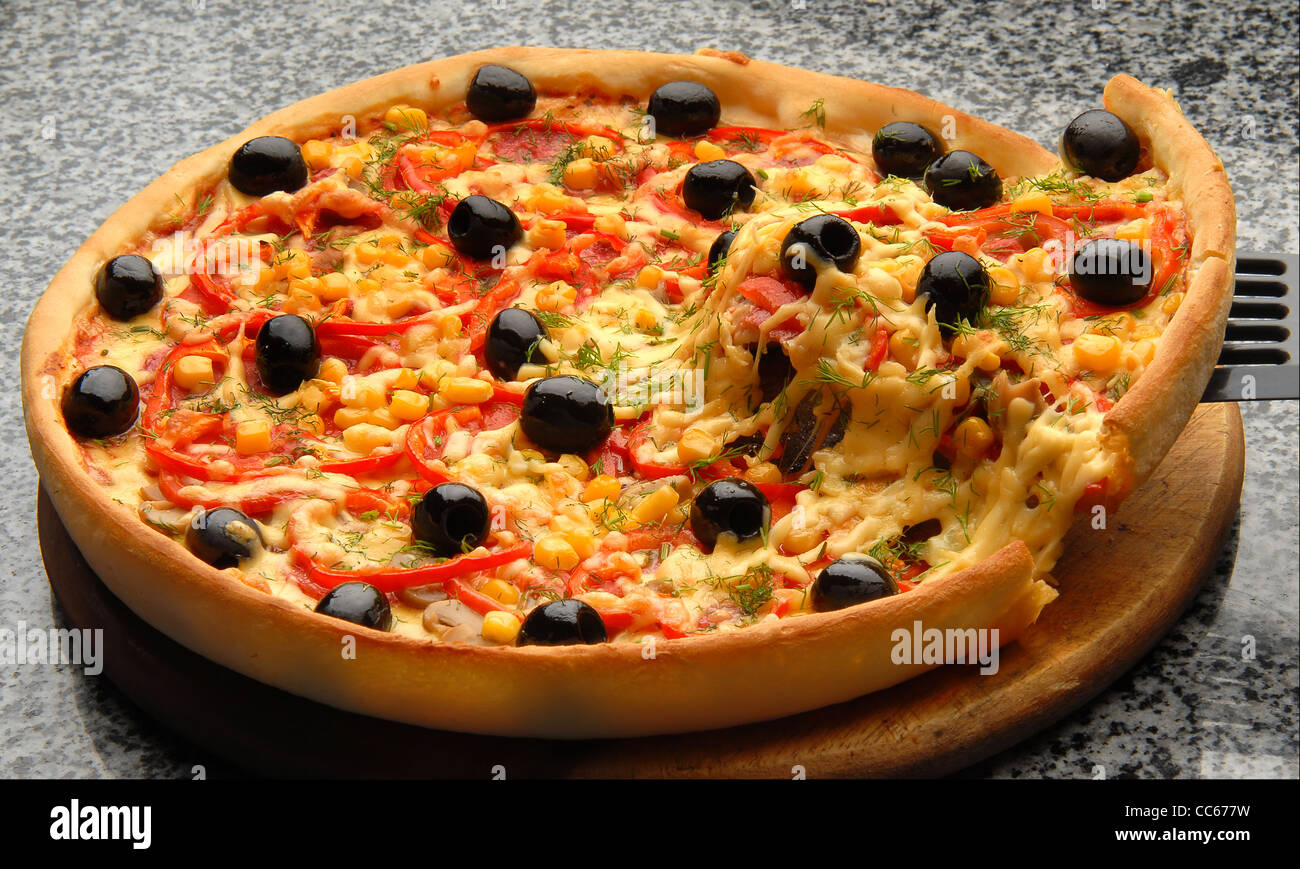 Round Italian pizza with salami, olives, capsicum and cheese Stock