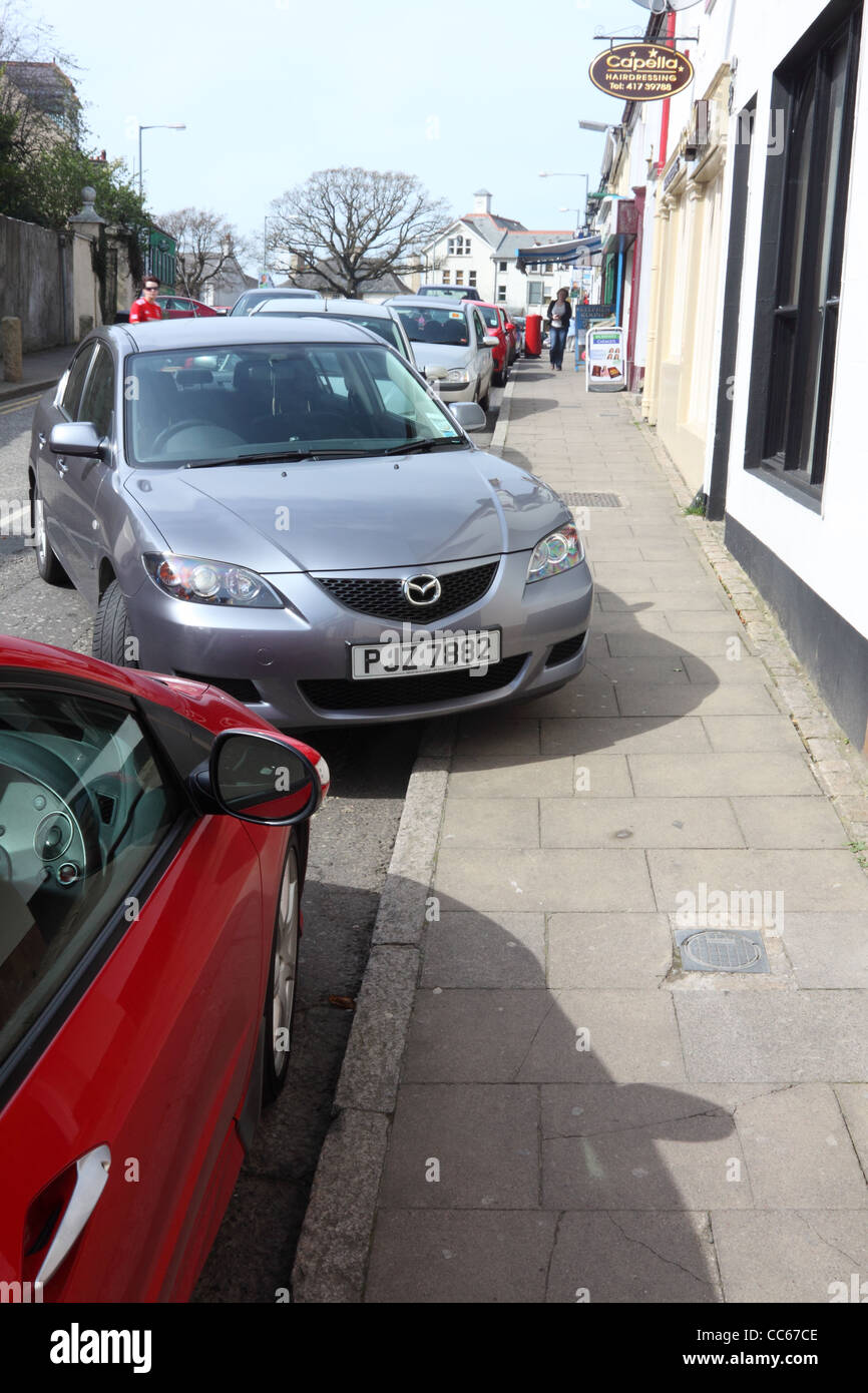 Car badly parked on pavement in Rostrevor, County Down, Northern Ireland Stock Photo