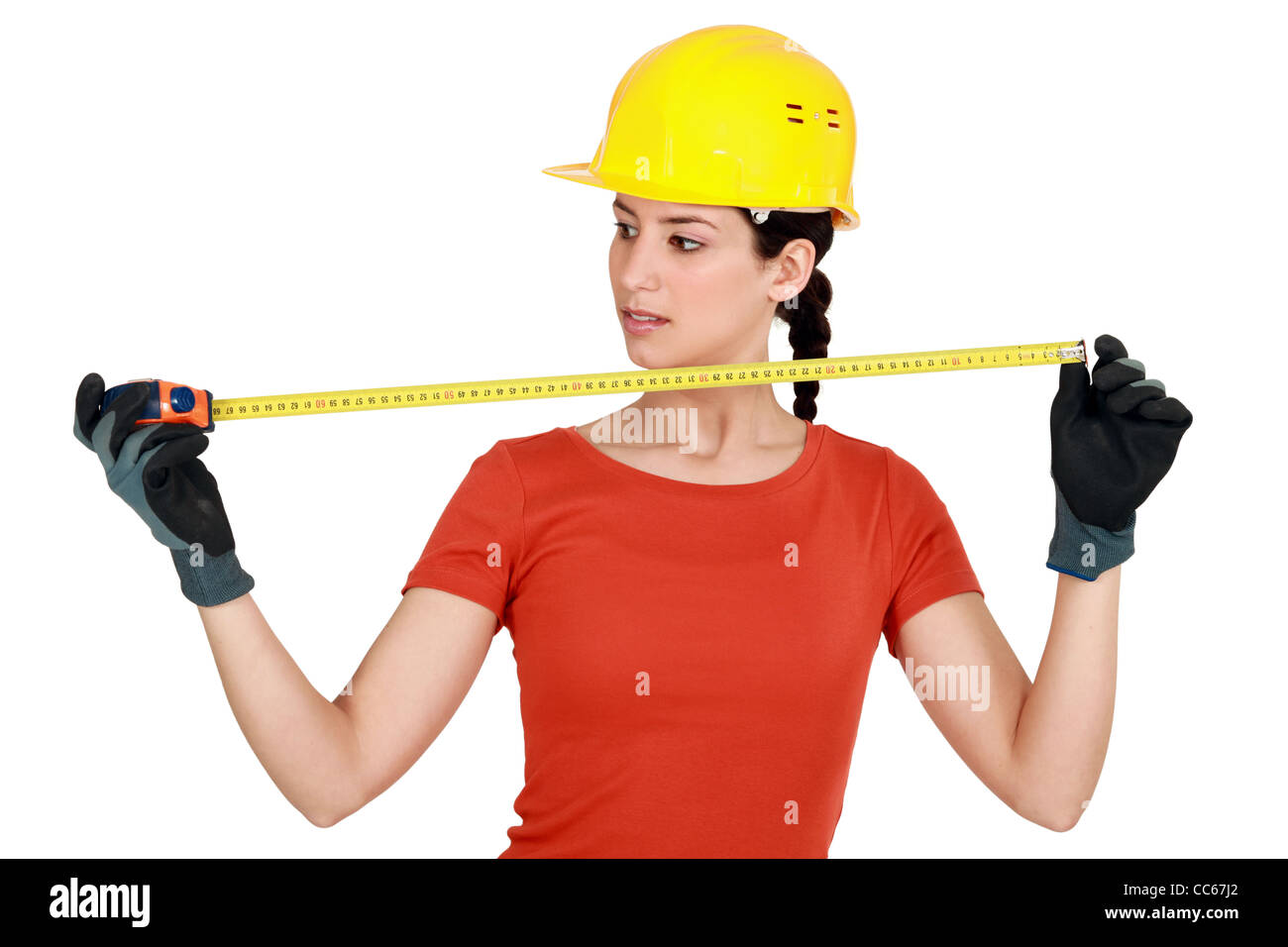 Tradeswoman using a measuring tape Stock Photo