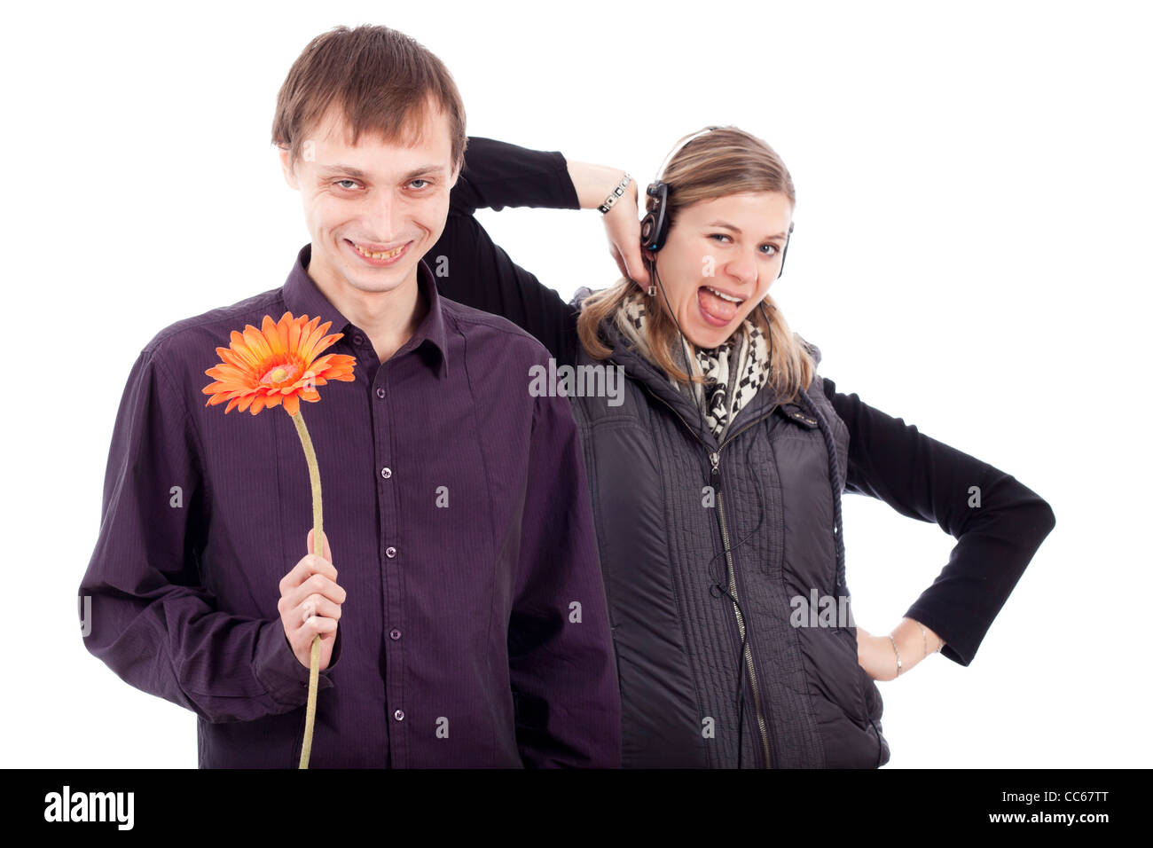 Funny weird couple, ugly man holding flower and rebel woman, isolated on white background. Beauty and the Beast concept. Stock Photo