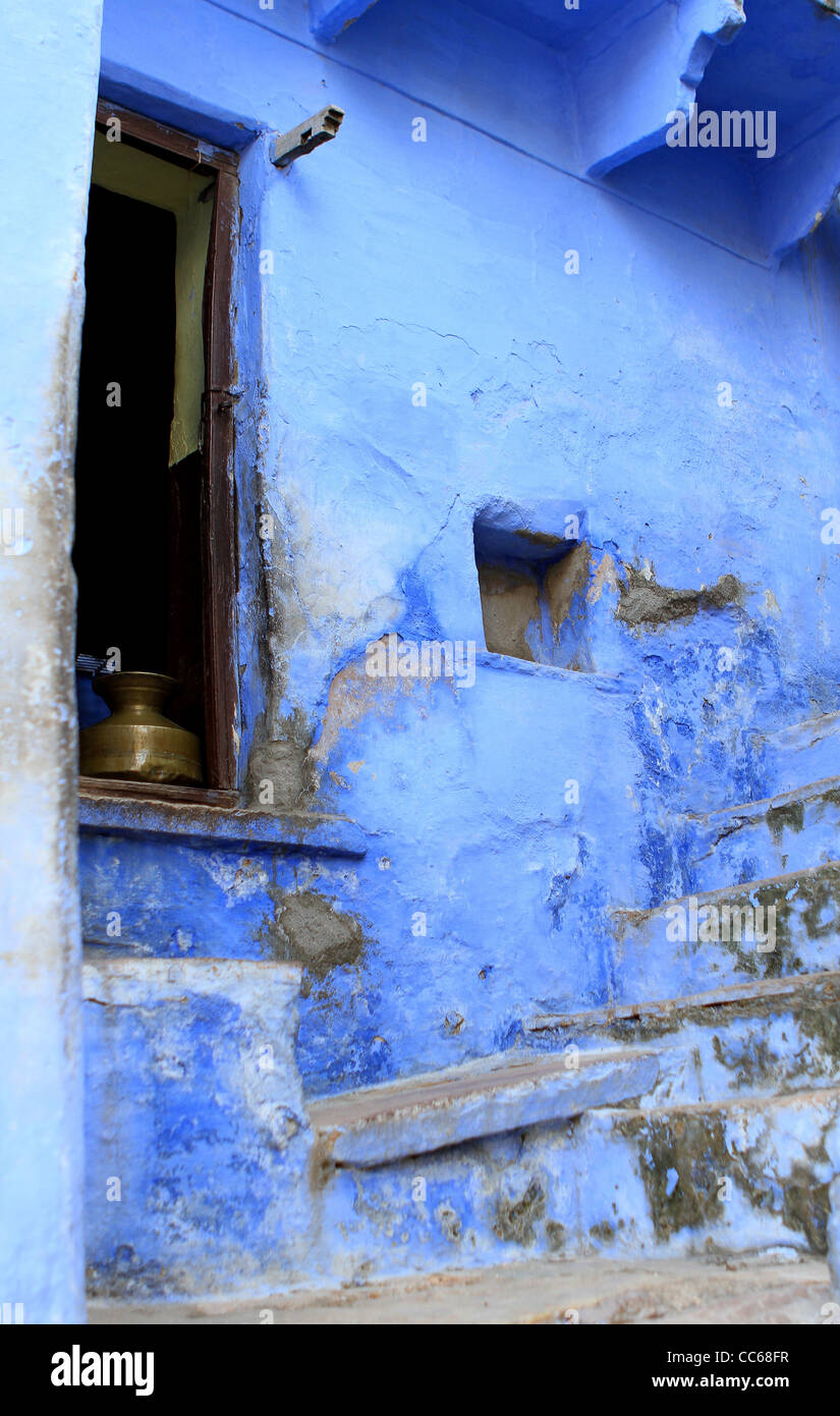Copper pot in window of traditional blue painted house. Bundi