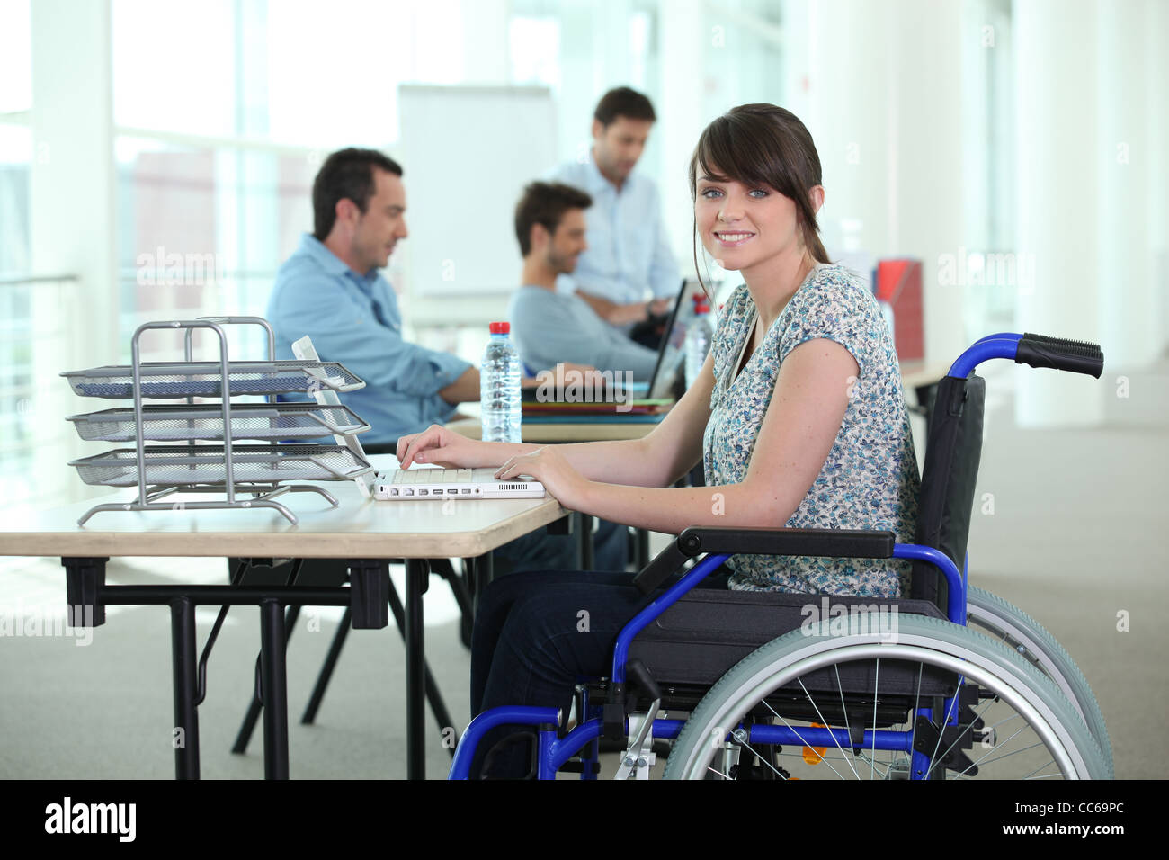 Woman in wheelchair with laptop computer Stock Photo - Alamy