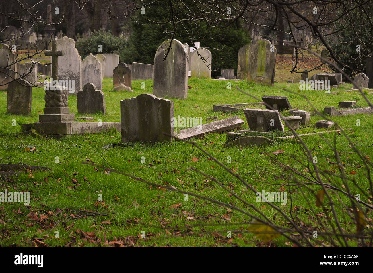 Tombstones in a cemetery on a gray day. Stock Photo