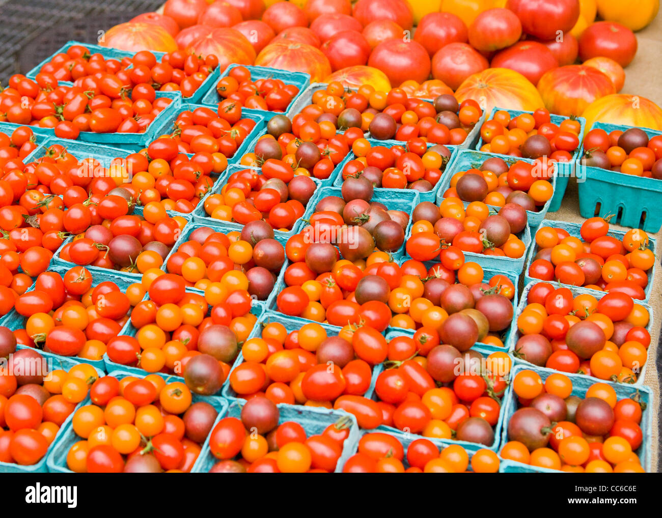 Organic cherry tomatoes in baskets Stock Photo