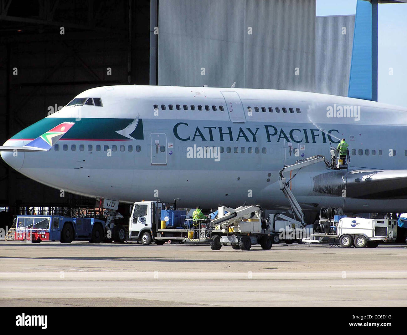 Cathay Pacific Boeing 747-400 (B-HUD) being cleaned in the maintenance area at London (Heathrow) Airport, England. Stock Photo
