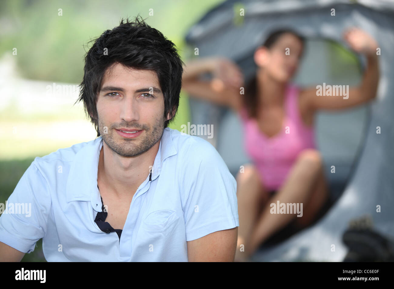 Couple waking up on a camping trip Stock Photo