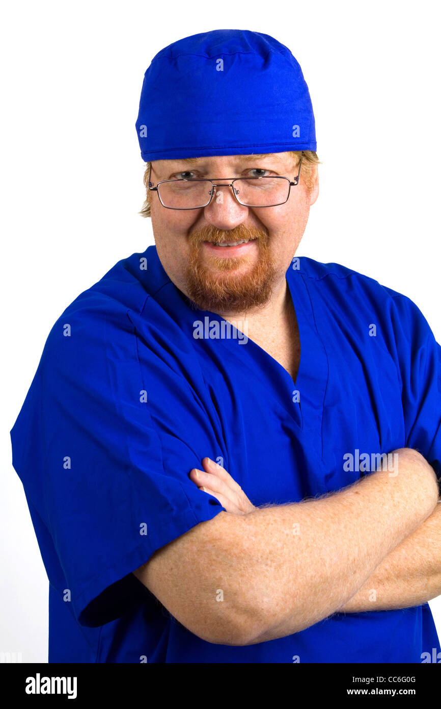 Smiling male nurse wears blue scrubs with arms crossed. Stock Photo