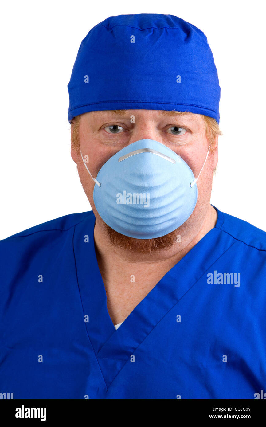 Surgeon in blue scrubs wears a surgical mask to prevent the spread of germs. Stock Photo