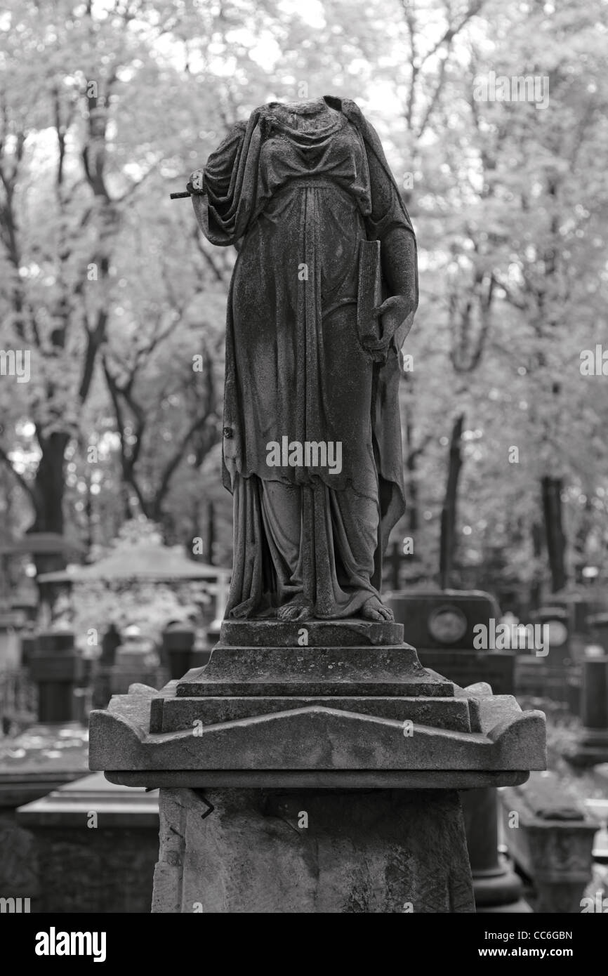 Beheaded sculpture on an old tombstone. BW photograph. Shallow depth of field. Stock Photo