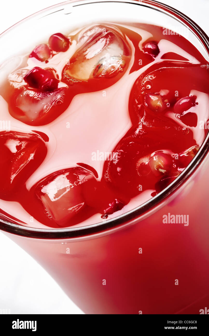 Red beverage with ice cubes. Close-up, tilt view. Stock Photo