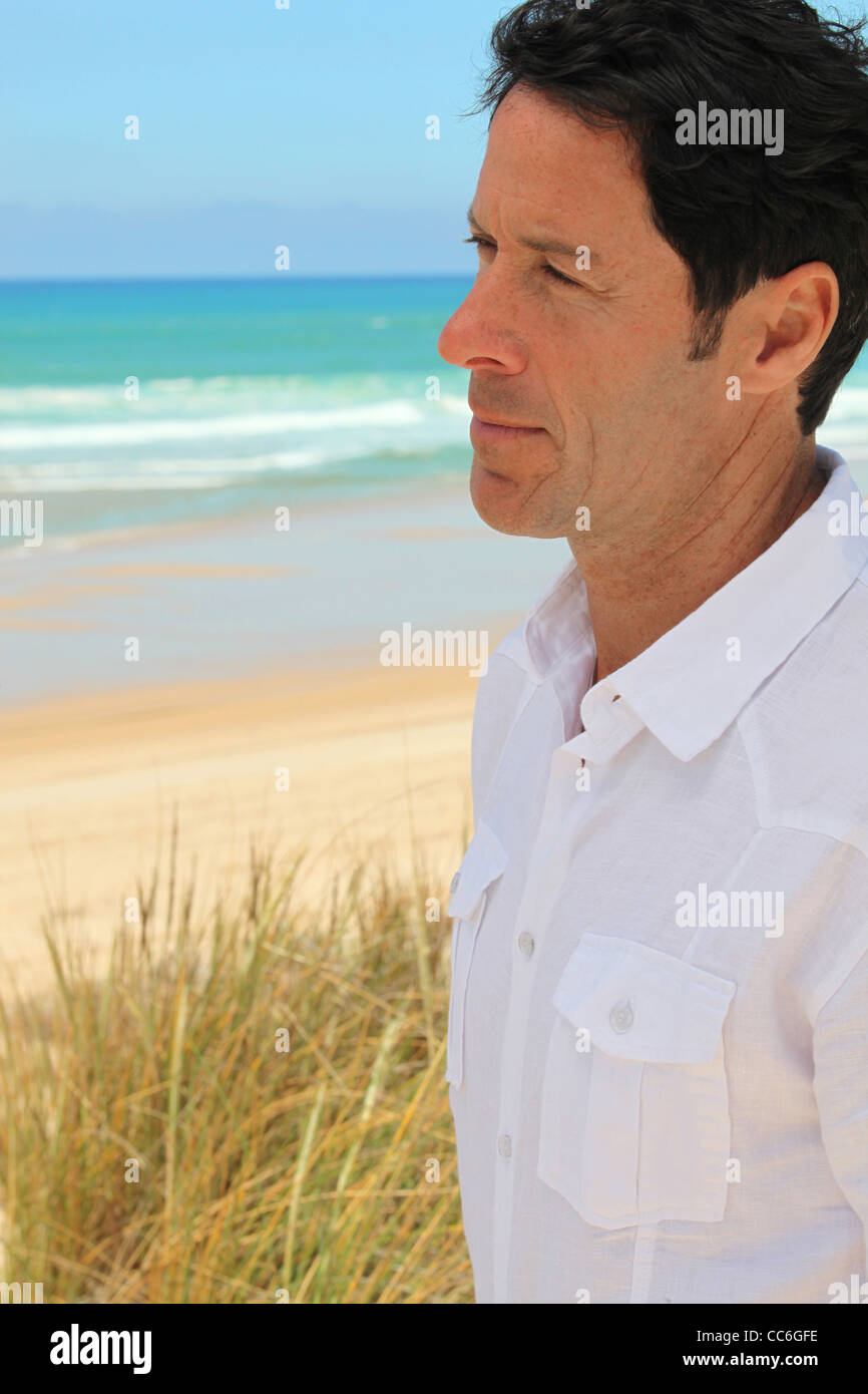 Man looking out to sea Stock Photo - Alamy