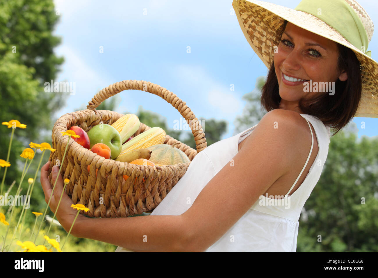 Woman with basket of fruit Stock Photo - Alamy