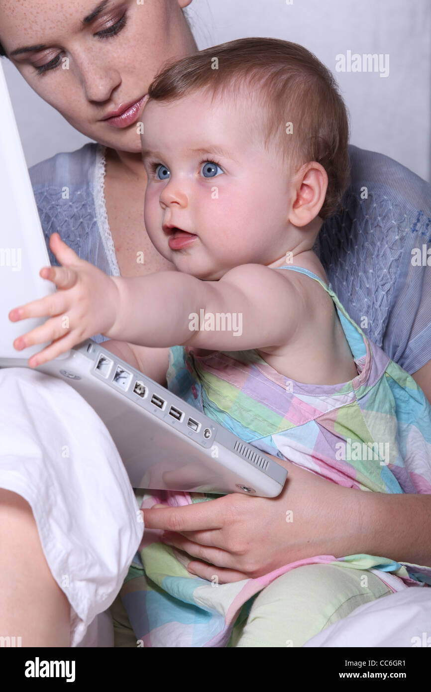 Mother and baby with a laptop Stock Photo