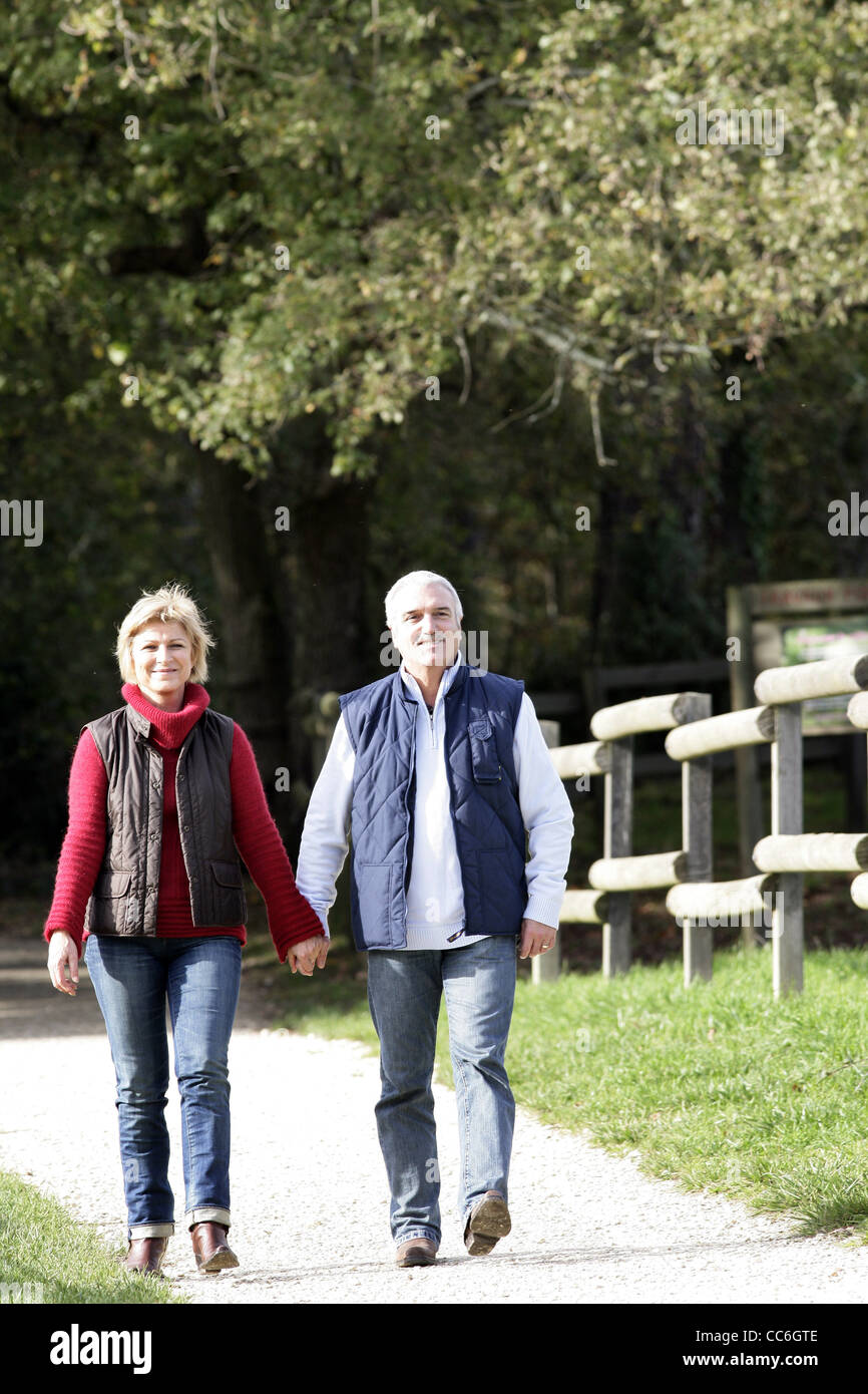 Couple walking down path Stock Photo - Alamy