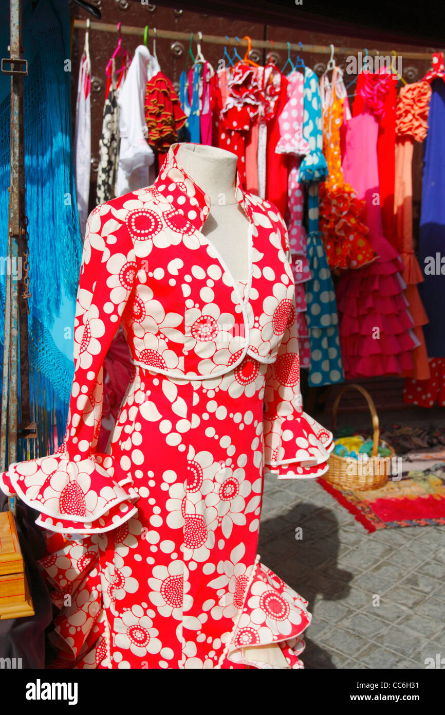 Flamenco dresses on market stall on famous street market in calle Feria, in Barrio Macarena, Seville, Spain, Europe Stock Photo