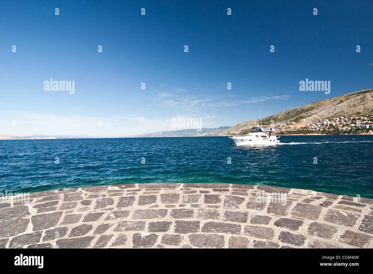 the mole and sea with ship in city Senj - Croatia Stock Photo
