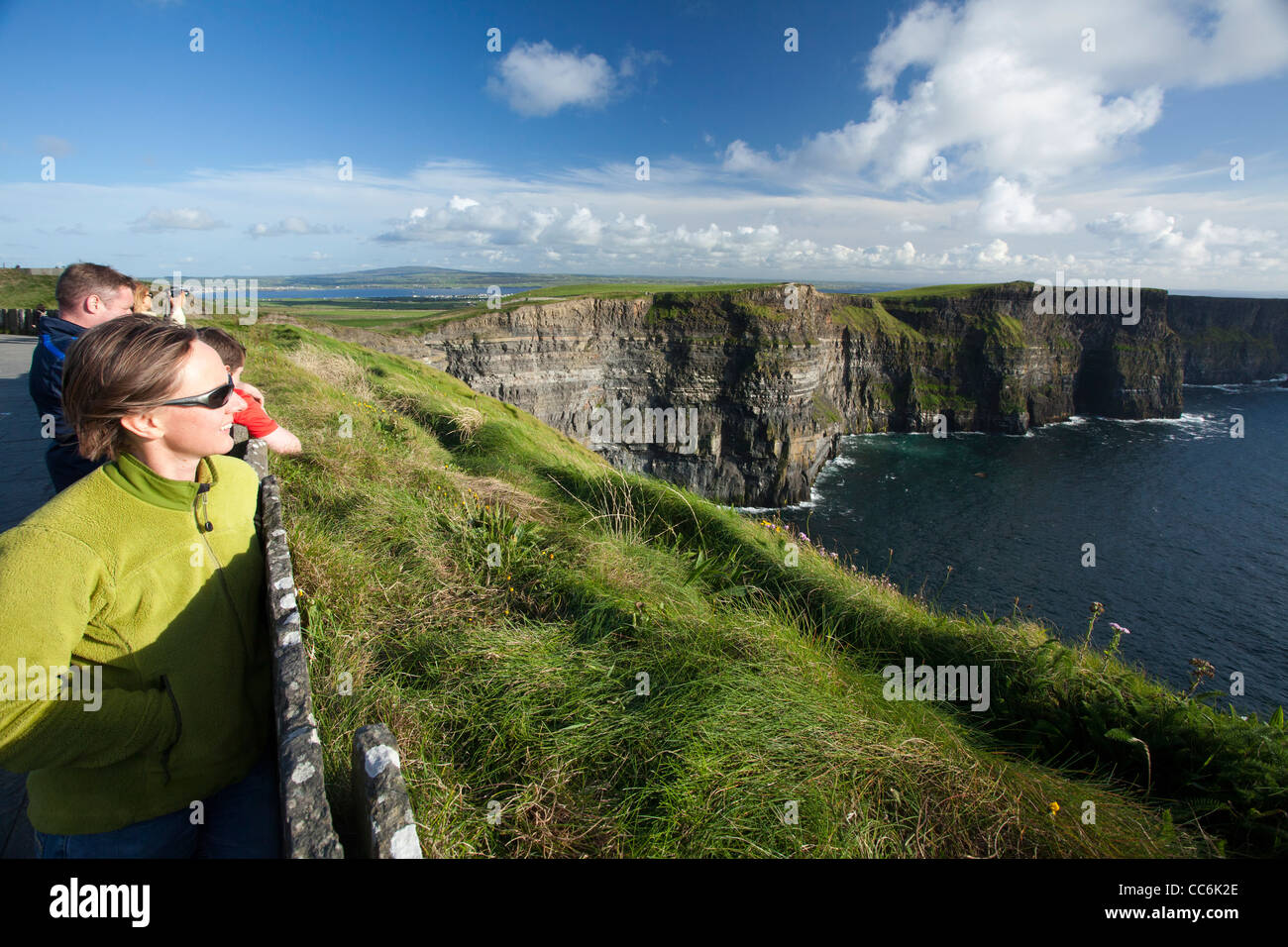 Tourists enjoying the view at the Cliffs of Moher, The Burren, County Clare, Ireland. Stock Photo