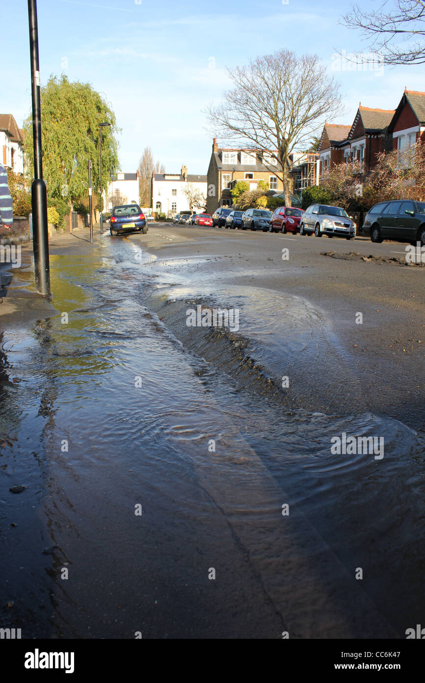Burst water main on street in London Stock Photo