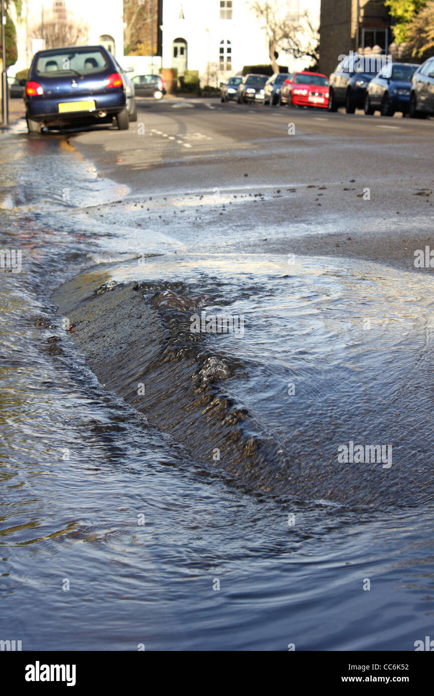 Burst water main on street in London Stock Photo Alamy