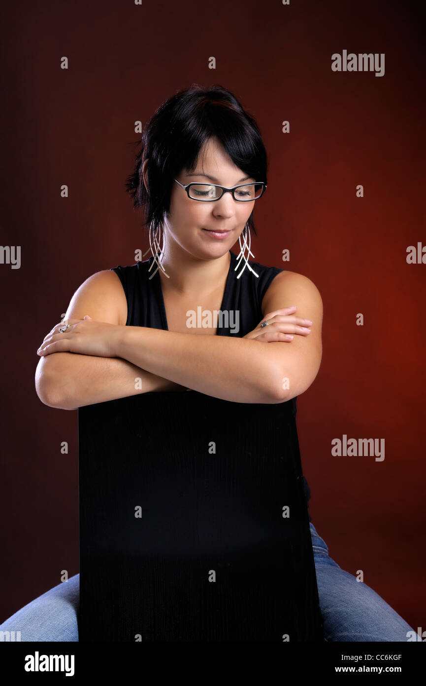 Woman glasses seated indoors hi-res stock photography and images - Alamy