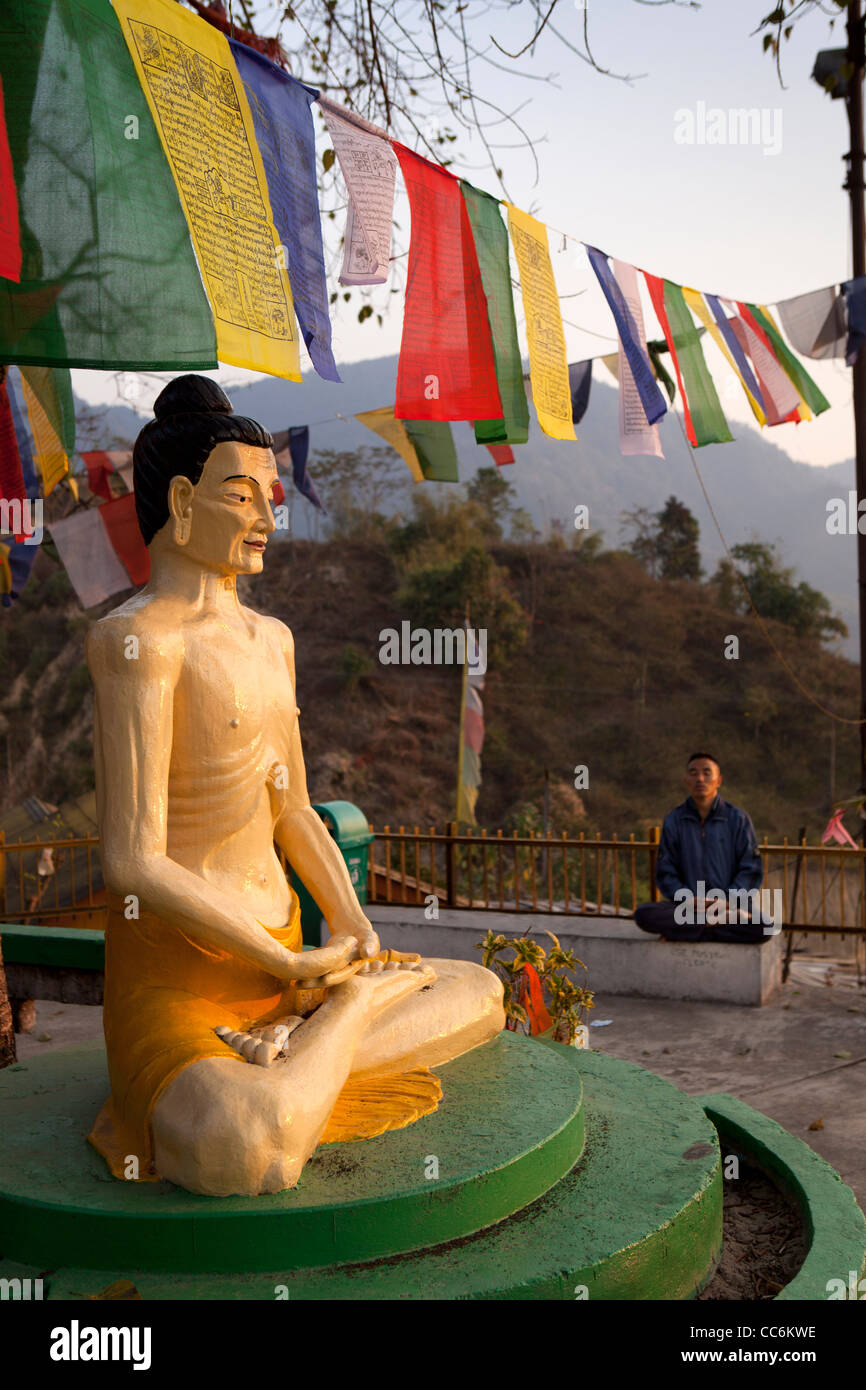 India, Arunachal Pradesh, Itanagar, Buddha Vihar Tibetan Buddhist Temple starving Buddha below prayer flags Stock Photo