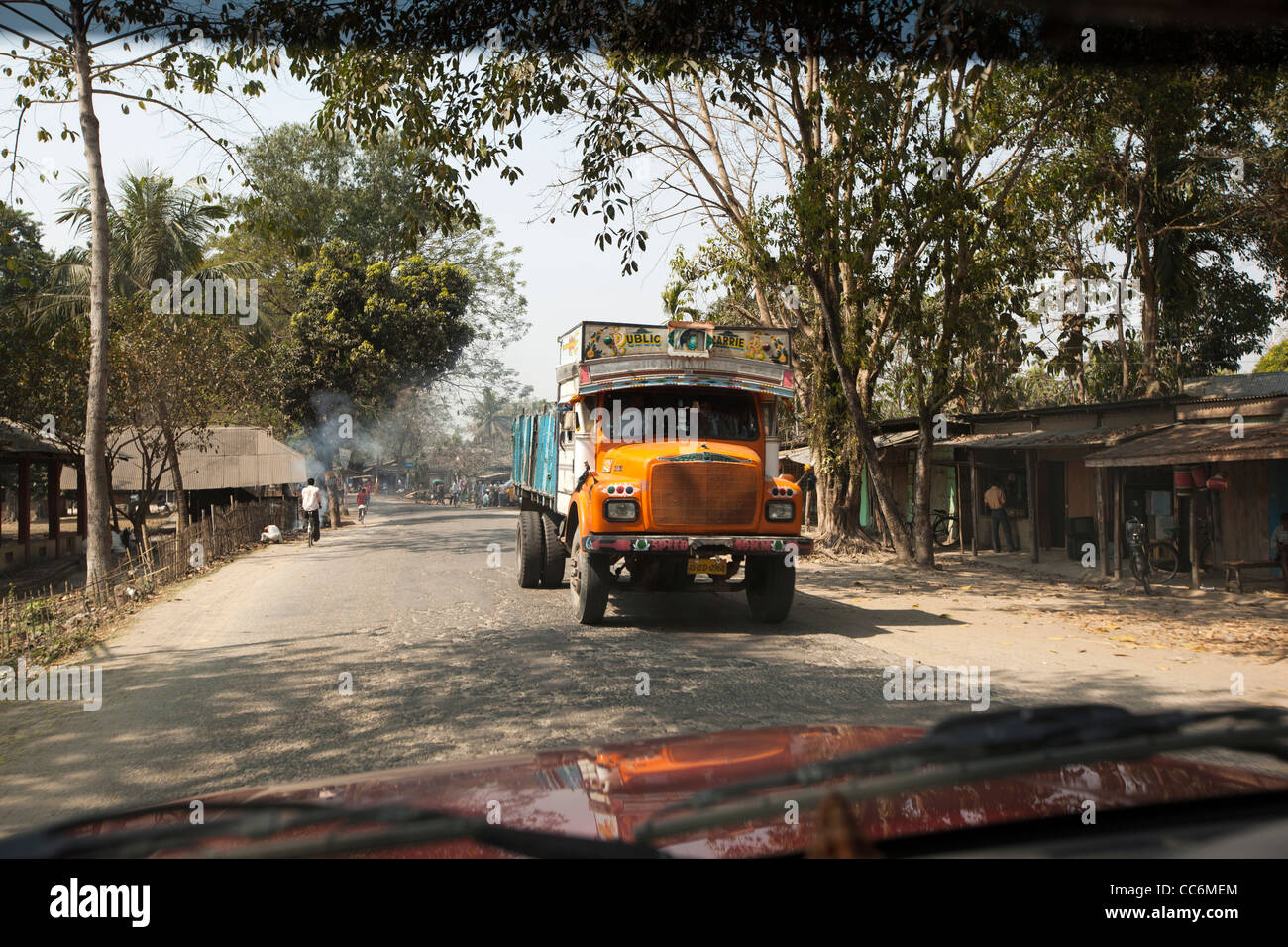 India, Assam, Balipari, lorry on village road with poor surface Stock Photo