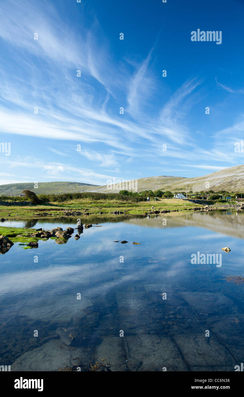 The limestone landscape of The Burren reflected in Ballyvaughan Bay, County Clare, Ireland. Stock Photo