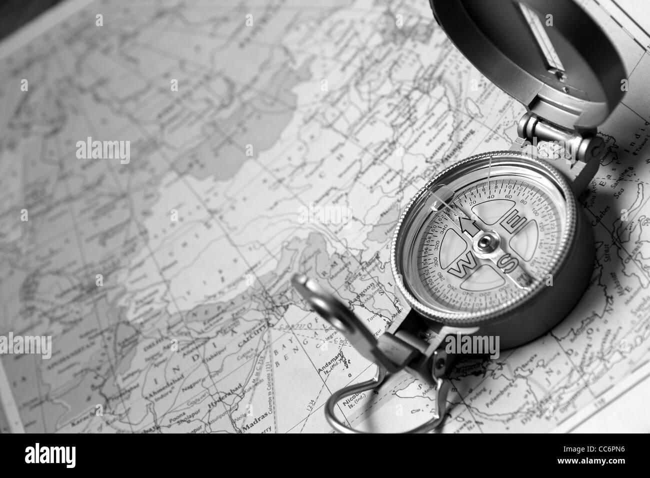 A compass on the world map of the atlas. Stock Photo