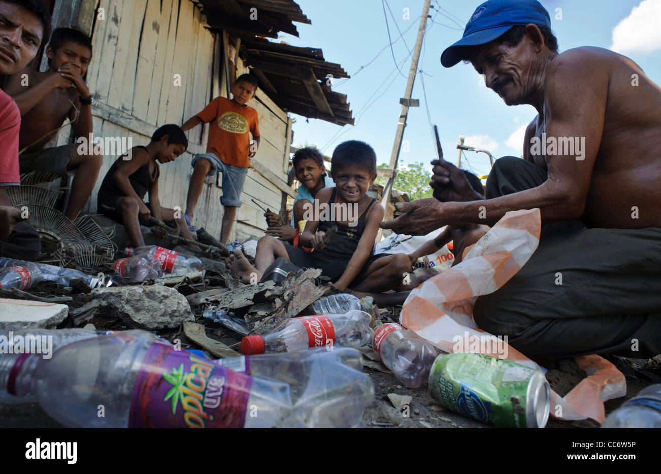 Three generations of a family making ends meet by recycling metal and plastic that they gather in San Pedro Sula. Los Bordos Stock Photo