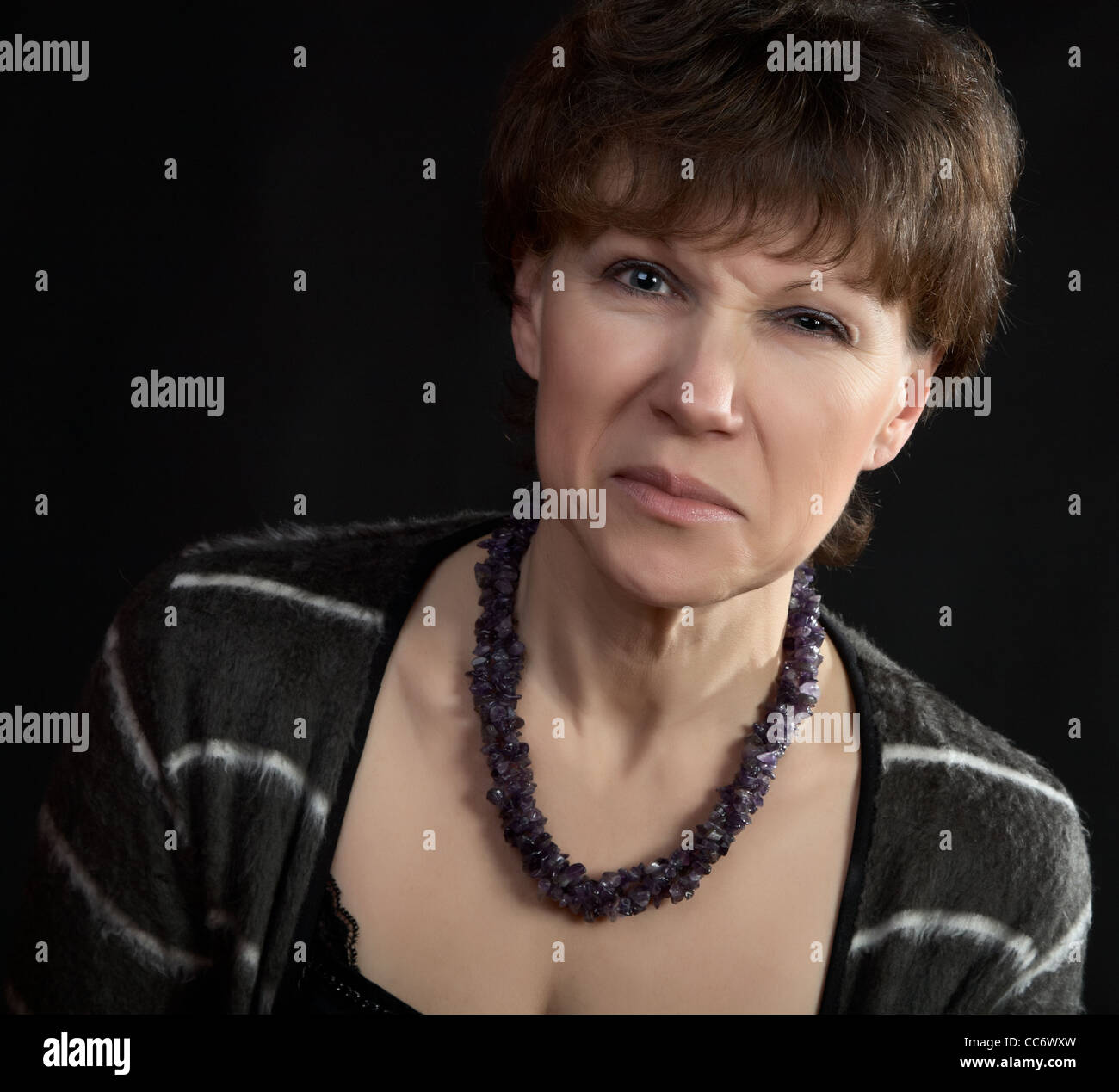 The woman with discontent grimace on a black background Stock Photo