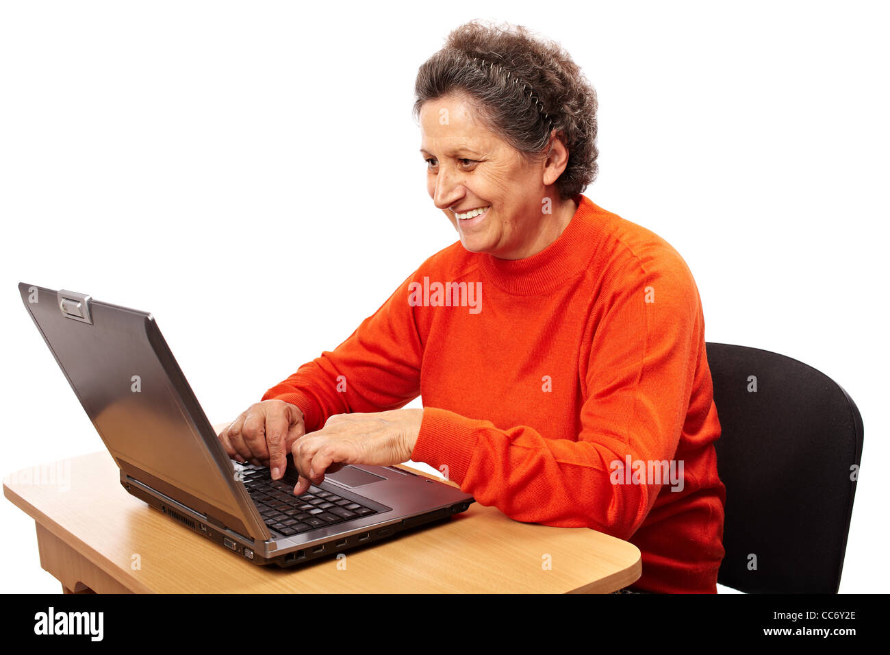Senior woman learning to use the computer, isolated on white background ...