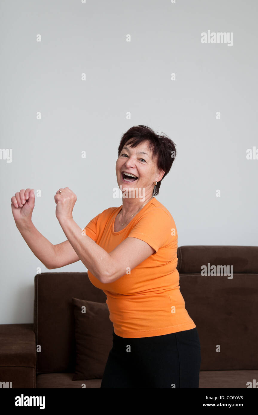 Senior fitness woman exercising at home Stock Photo