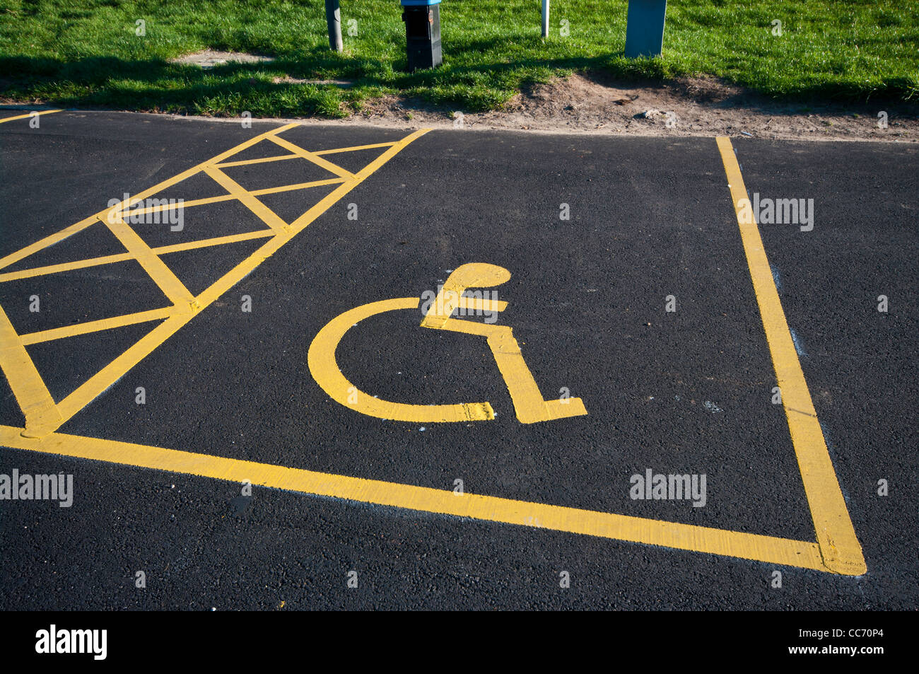 Disabled Parking Space Sign Painted On The Tarmac In A Car Park carpark UK Stock Photo