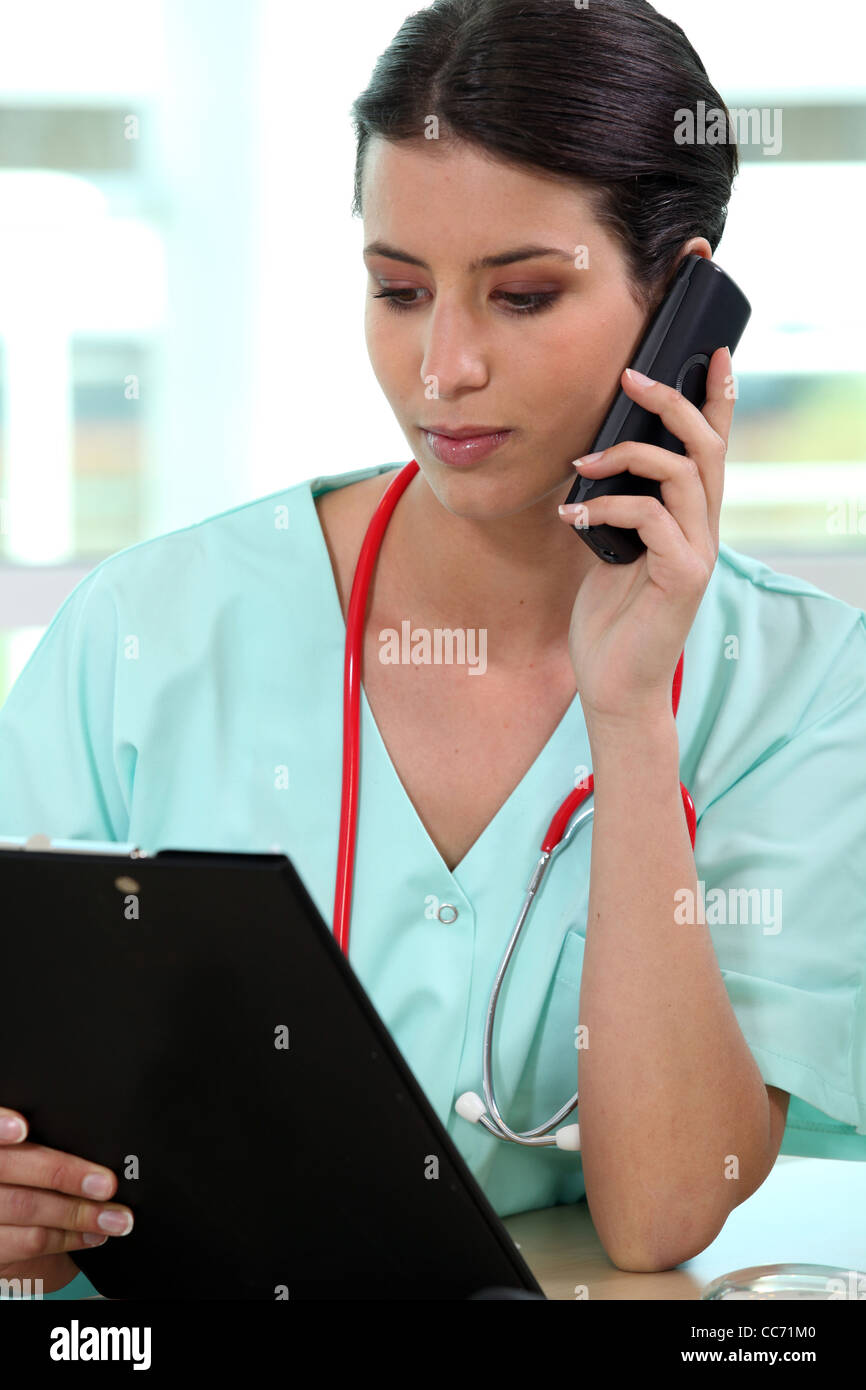 Female medic making a telephone call Stock Photo