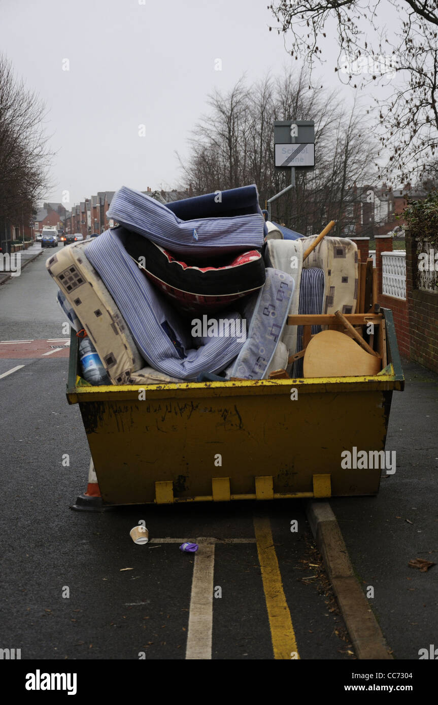 Mattress and furniture filled skip Stock Photo Alamy