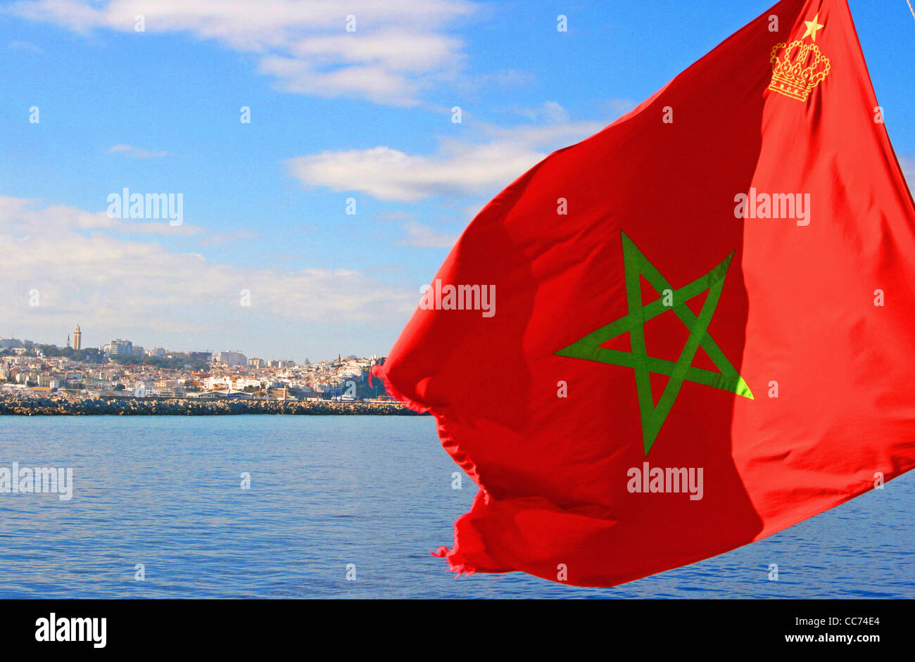 The Moroccan flag in foreground and the city of Tangier in background seen from the ferry to Tarifa, Morocco. Stock Photo