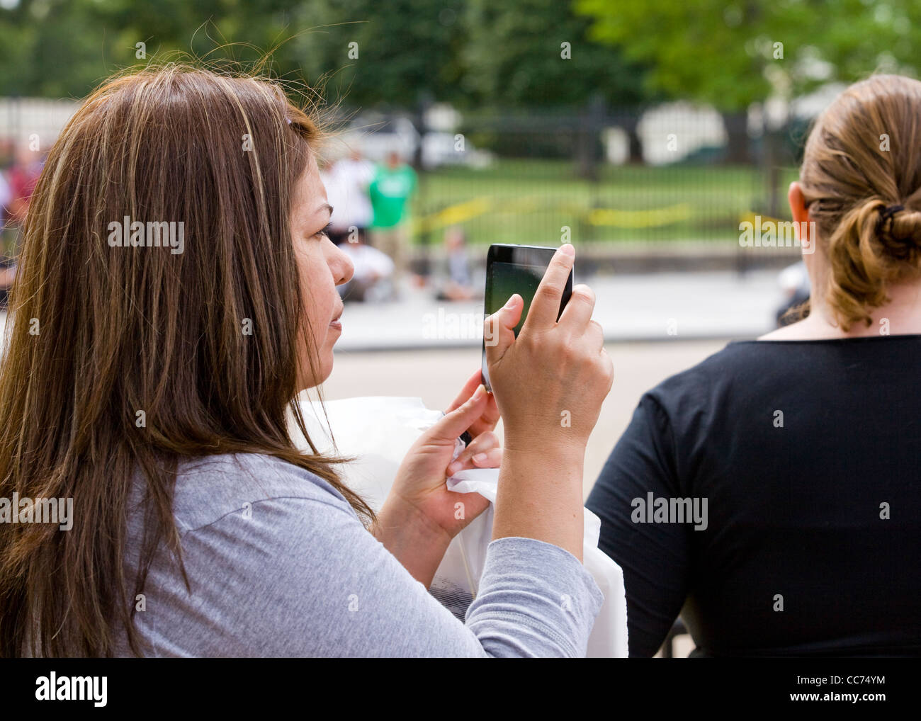 A woman taking video with a tablet PC - USA Stock Photo