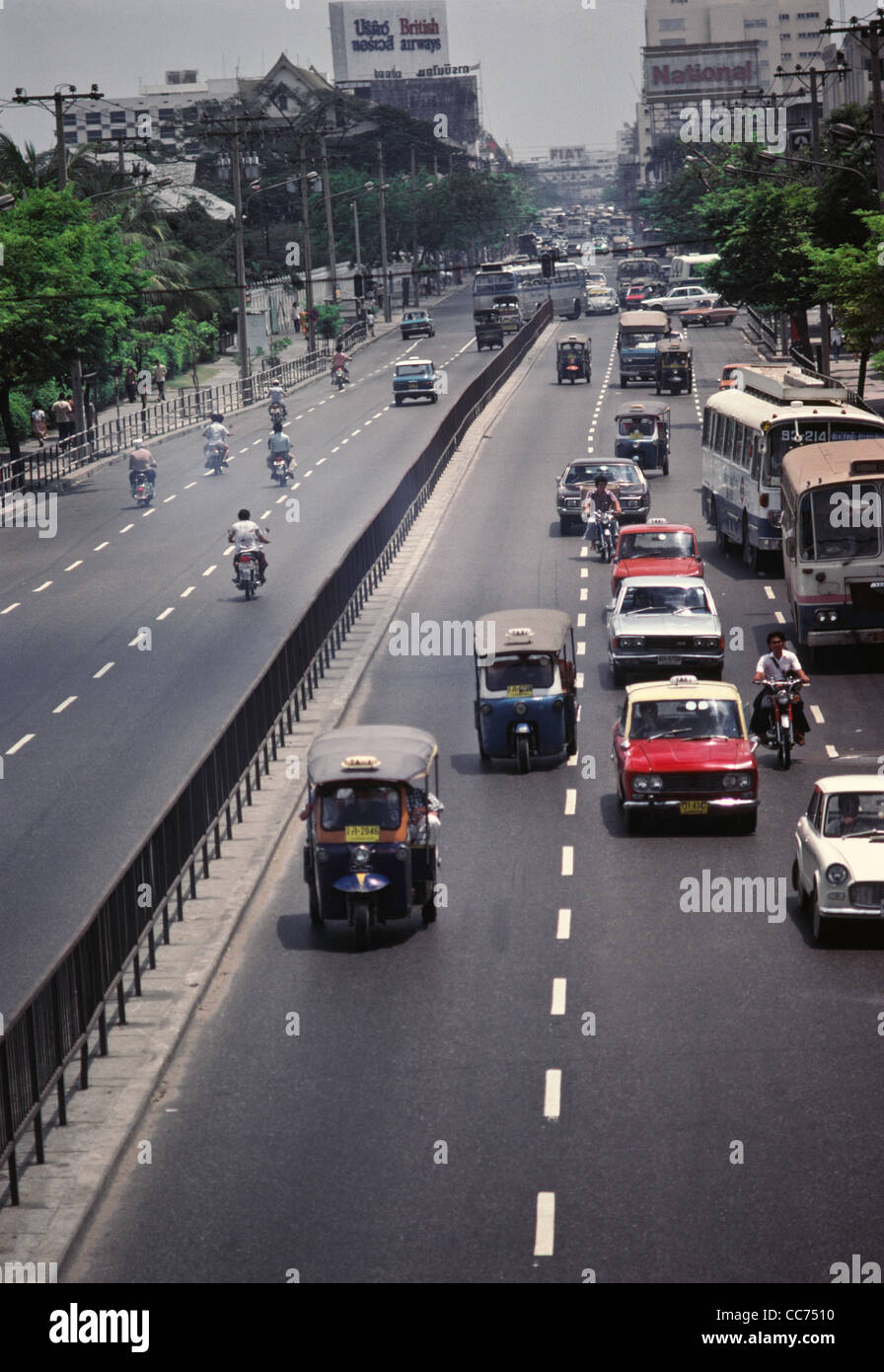 1977 Traffic with Old Tuk-Tuk Taxis, Six Lane Highway, Bangkok, Thailand Stock Photo