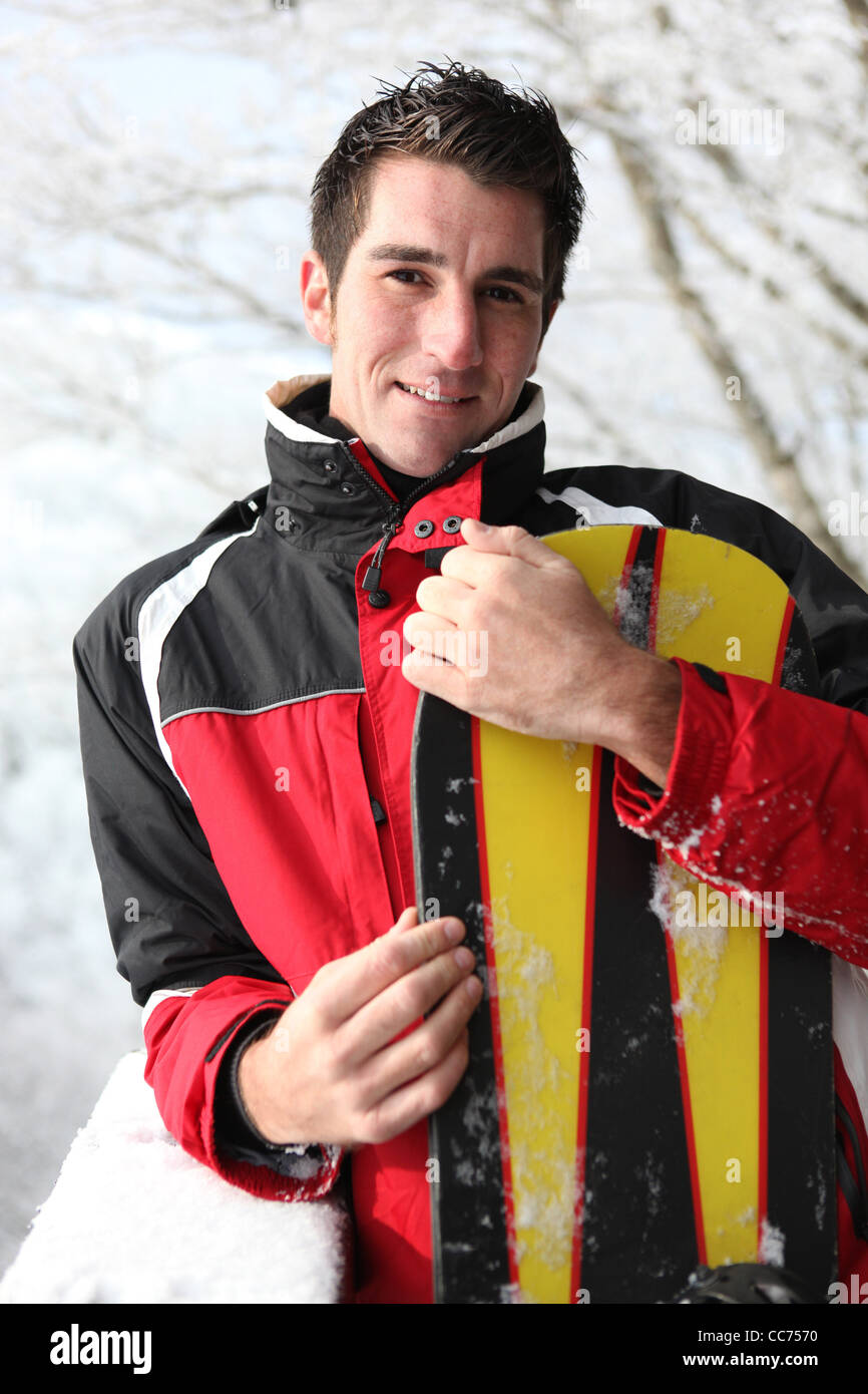 Man holding his snowboard Stock Photo - Alamy